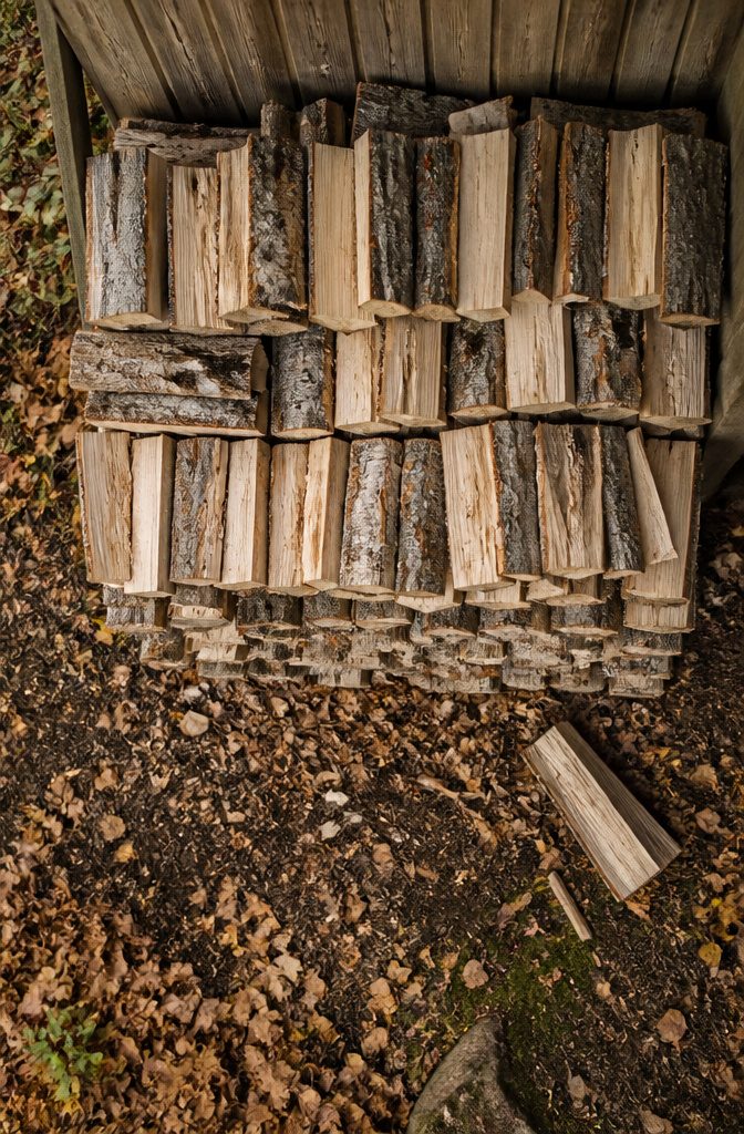 How to Store Wood: 7 Steps for Proper Firewood Storage 4 Flat lumber boards stacked with narrow spacers between each layer